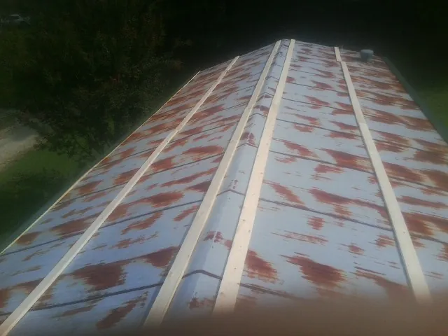Rusted metal roof panels with new wood purlins before replacement — Storm Damage Roof Repair in Frenchburg by Roofing Brothers